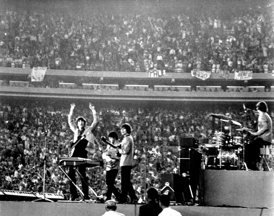 The Beatles perform at Shea Stadium, New York on 15th August 1965.