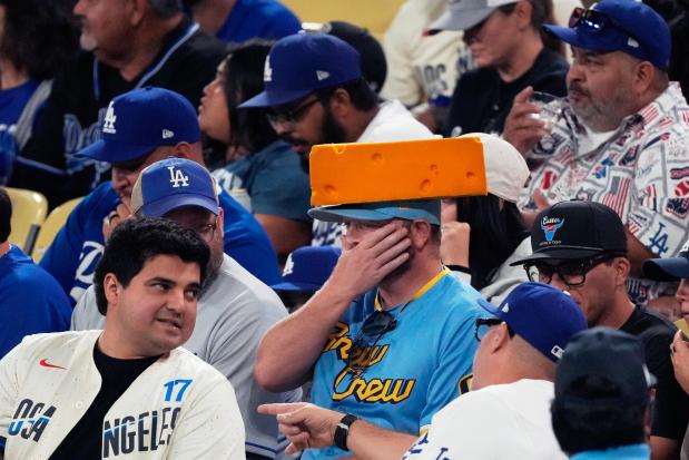 Fans watch during the fifth inning in Game 4 of baseball's National League Championship Series between the Milwaukee Brewers and the Los Angeles Dodgers, Friday, Oct. 17, 2025, in Los Angeles. (AP Photo/Mark J. Terrill)