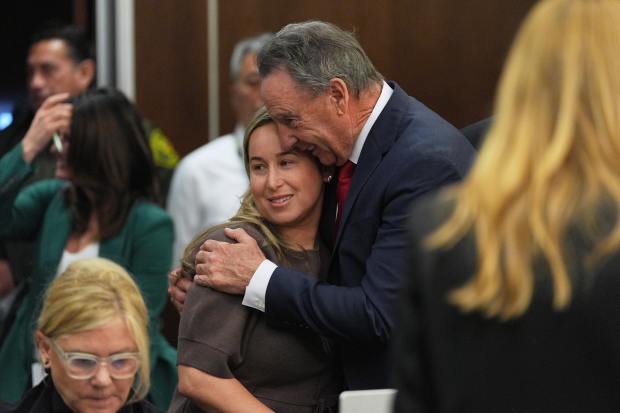 Carli Skaggs, widow of pitcher Tyler Skaggs, is embraced by...