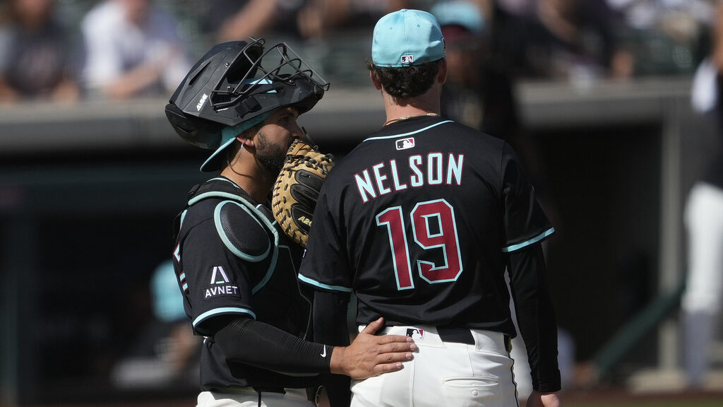 Diamondbacks catcher Adrian Del Castillo talks with pitcher Ryne Nelson