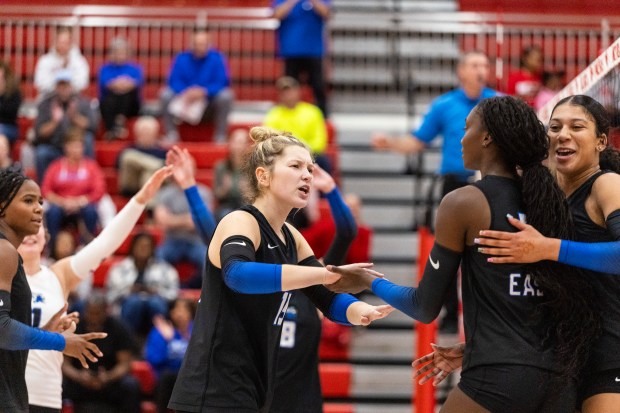Lincoln-Way East's Brooklyn Ritter (13) congratulates Klarke Mosby after a kill against Homewood-Flossmoor during a Southwest Suburban Conference game in Flossmoor on Tuesday, Oct. 21, 2025. (Vincent D. Johnson / for the Daily Southtown)