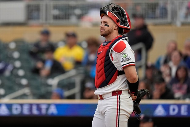 Twins catcher Ryan Jeffers stands on the field waiting between pitches.