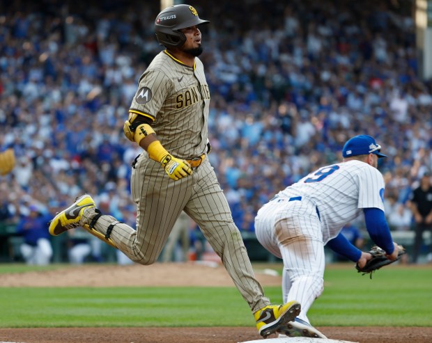 Luis Arraez #4 of the San Diego Padres is thrown out at first base in the fourth inning as Michael Busch #29 of the Chicago Cubs catches the ball during Game 3 of the NL Wild Card Series at Wrigley Field on Oct. 2, 2025 in Chicago, Illinois. (Photo by K.C. Alfred / The San Diego Union-Tribune)