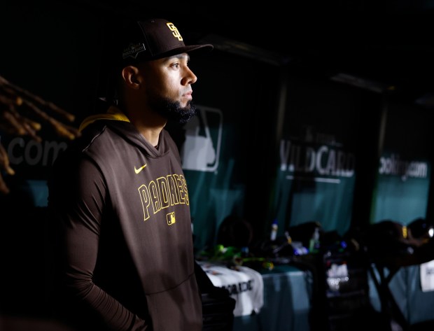 Robert Suarez #75 of the San Diego Padres watches as Chicago Cubs celebrate a 3-1 win in Game 3 of the NL Wild Card Series at Wrigley Field on Oct. 2, 2025 in Chicago, Illinois. (Photo by K.C. Alfred / The San Diego Union-Tribune)