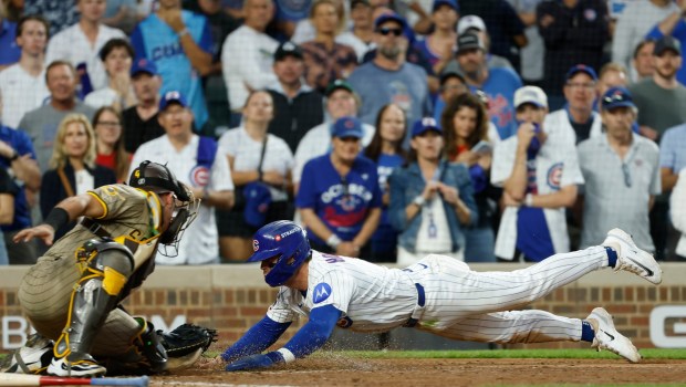 Freddy Fermin #54 of the San Diego Padres tags out Nico Hoerner #2 of the Chicago Cubs in the seventh inning during Game 3 of the NL Wild Card Series at Wrigley Field on Oct. 2, 2025 in Chicago, Illinois. (Photo by K.C. Alfred / The San Diego Union-Tribune)