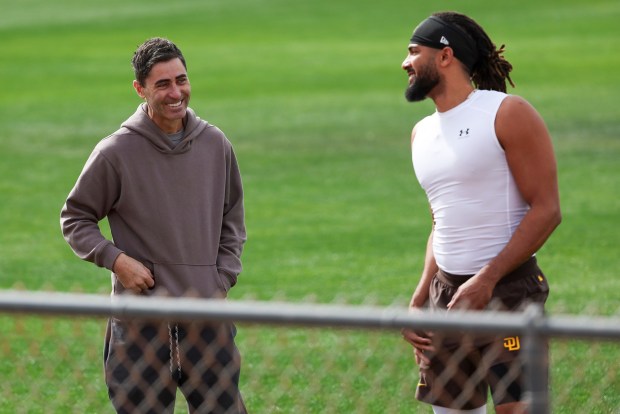 Padres executive A.J. Preller laughs with Fernando Tatis Jr. during spring training workouts Feb. 13, 2025 in Peoria, Ariz.. (Meg McLaughlin / The San Diego Union-Tribune)
