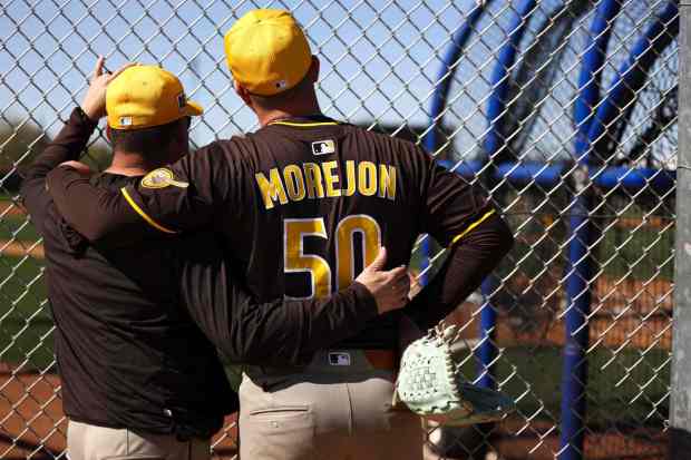 Pitching coach Ruben Niebla hugs Adrian Morejon during Padres spring training workouts at the Peoria Sports Complex on Tuesday, Feb. 18, 2025 in Peoria, Ariz.. (Meg McLaughlin / The San Diego Union-Tribune)