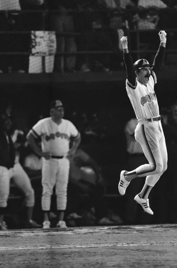 San Diego Padres Kurt Bevacqua, right, leaps into air with elation on the way to first base as he sees his fifth-inning, three-run homer clear the wall during Game 2 of the World Series at San Diego, Oct. 10, 1984. Bevacqua's homer put the Padres in front of the Detroit Tigers 5-3 in a World Series game. (AP Photo)