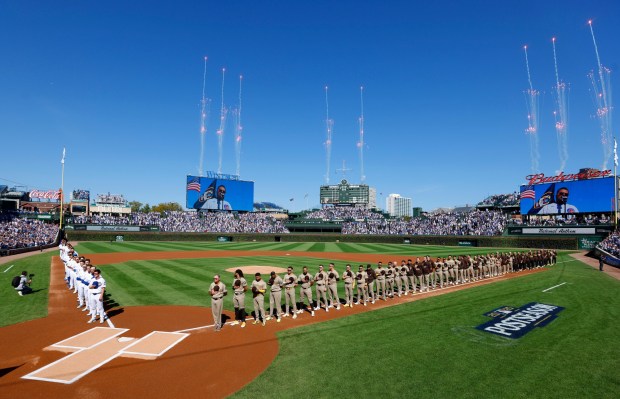 The San Diego Padres and Chicago Cubs stand for the national anthem before Game 1 of the NL Wild Card Series at Wrigley Field on Sept. 30, 2025 in Chicago, Illinois. (Photo by K.C. Alfred / The San Diego Union-Tribune)