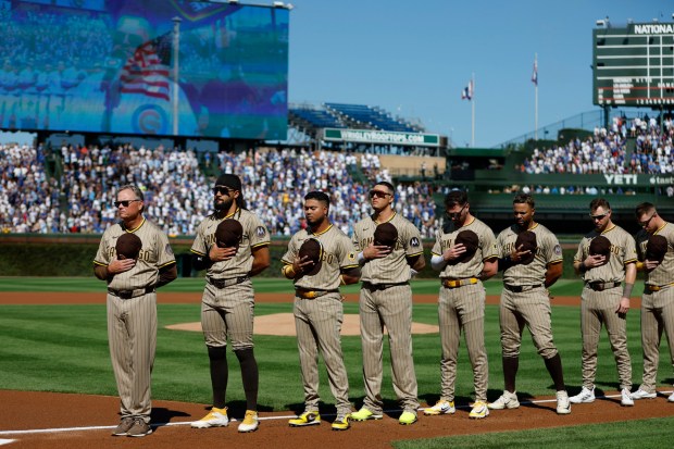 The San Diego Padres stand for the national anthem before Game 1 of the NL Wild Card Series against the Chicago Cubs at Wrigley Field on Sept. 30, 2025 in Chicago, Illinois. (Photo by K.C. Alfred / The San Diego Union-Tribune)