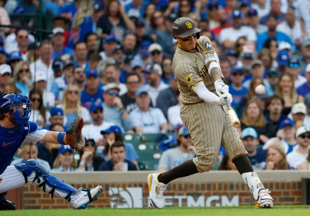 Manny Machado #13 of the San Diego Padres hits a two-run home run in the fifth inning against the Chicago Cubs during Game 2 of the NL Wild Card Series at Wrigley Field on Oct. 1, 2025 in Chicago, Illinois. (Photo by K.C. Alfred / The San Diego Union-Tribune)