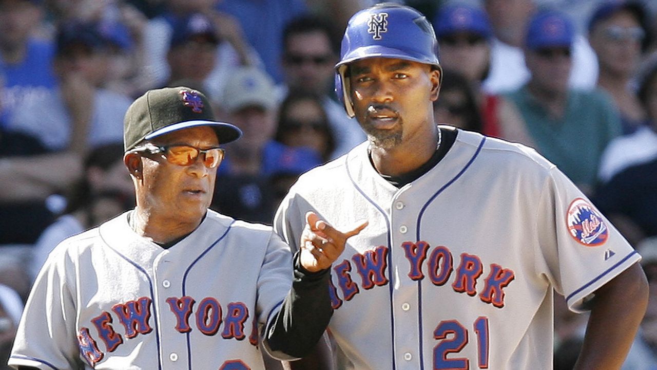New York Mets third base coach Sandy Alomar Sr., left, talks to Carlos Delgado at third base during the ninth inning of a baseball game against the Chicago Cubs, Friday, Aug. 3, 2007, in Chicago. The Mets won, 6-2. (AP Photo/Nam Y. Huh)