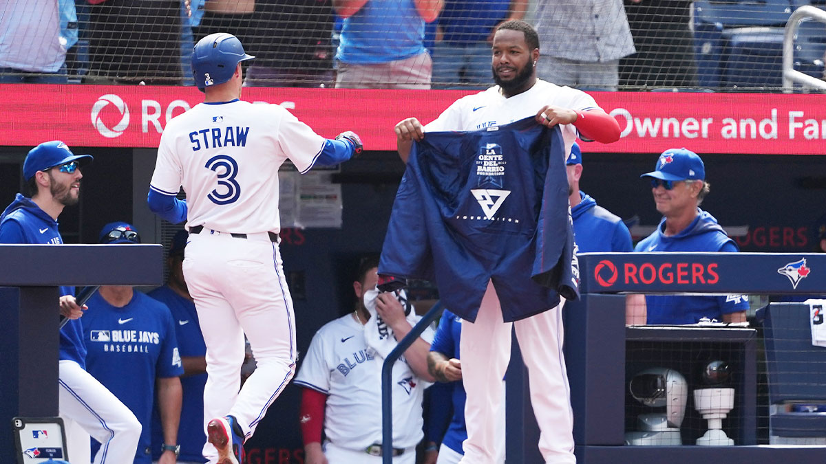 Toronto Blue Jays first base Vladimir Guerrero Jr. (27) prepares the home run jacket for right fielder Myles Straw (3) after hitting a three home home run against the Texas Rangers during the the second inning at Rogers Centre. 