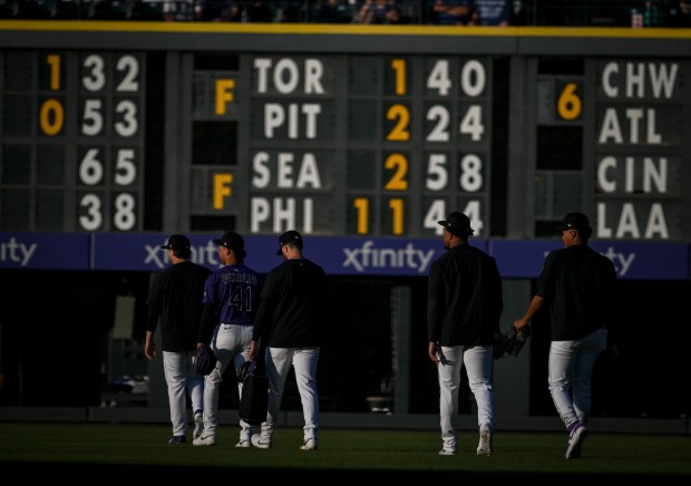 Members of the Colorado Rockies' pitching staff walk to the bullpen before the first inning against the Los Angeles Dodgers at Coors Field in Denver on Wednesday, Aug. 20, 2025. (Photo by AAron Ontiveroz/The Denver Post)
