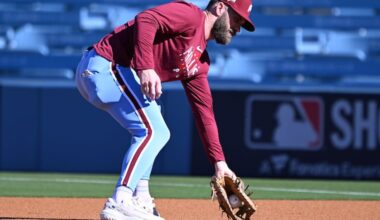Phillies' Bryce Harper fields a ball at first base during a practice in Los Angeles ahead of Game 3 of the NLDS.