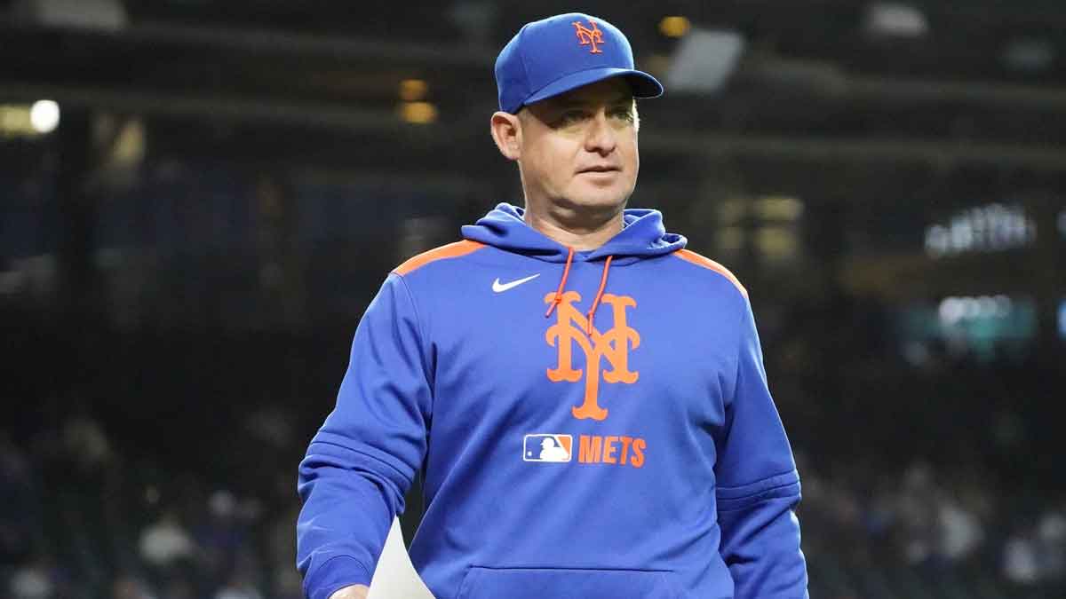 New York Mets manager Carlos Mendoza (64) on the field before a game against the Chicago Cubs at Wrigley Field. 