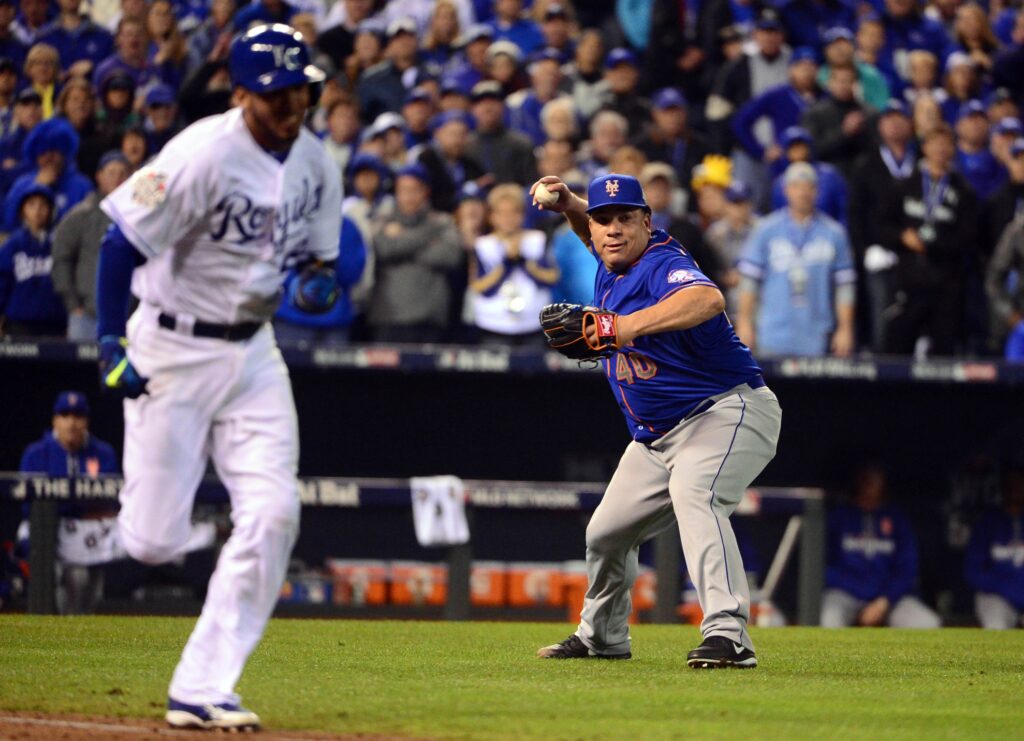 New York Mets pitcher Bartolo Colon (40) throws out Kansas City Royals shortstop Alcides Escobar (2) in the 12th inning in game one of the 2015 World Series at Kauffman Stadium. 