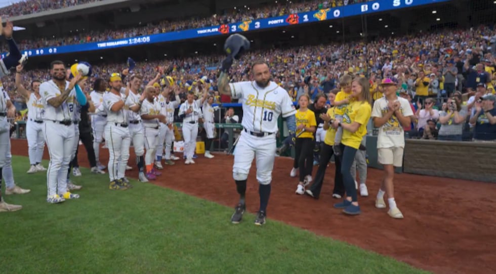 Retired Army Sergeant Lonnie Gaudet receives a standing ovation as he makes his Banana Ball...
