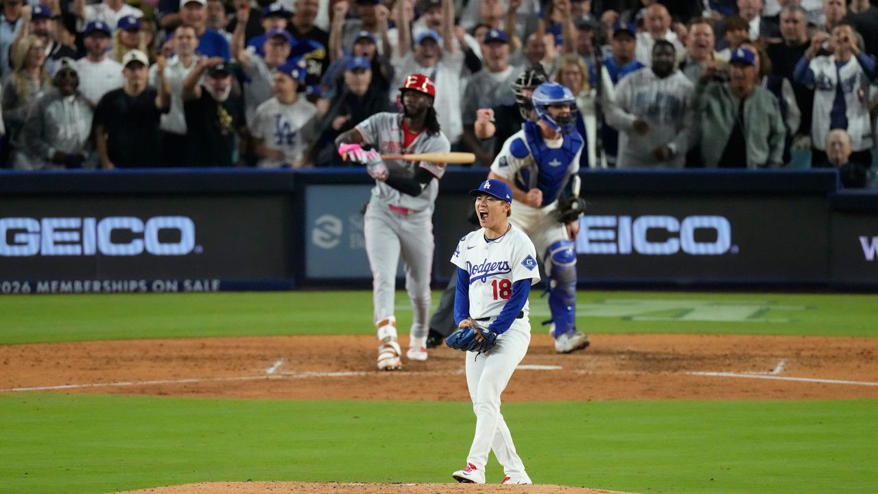 Los Angeles Dodgers pitcher Yoshinobu Yamamoto reacts after striking out Cincinnati Reds' Elly De La Cruz during the sixth inning in Game 2 of the National League Wild Card baseball playoff series Wednesday, Oct. 1, 2025, in Los Angeles. (AP Photo/Mark J. Terrill)