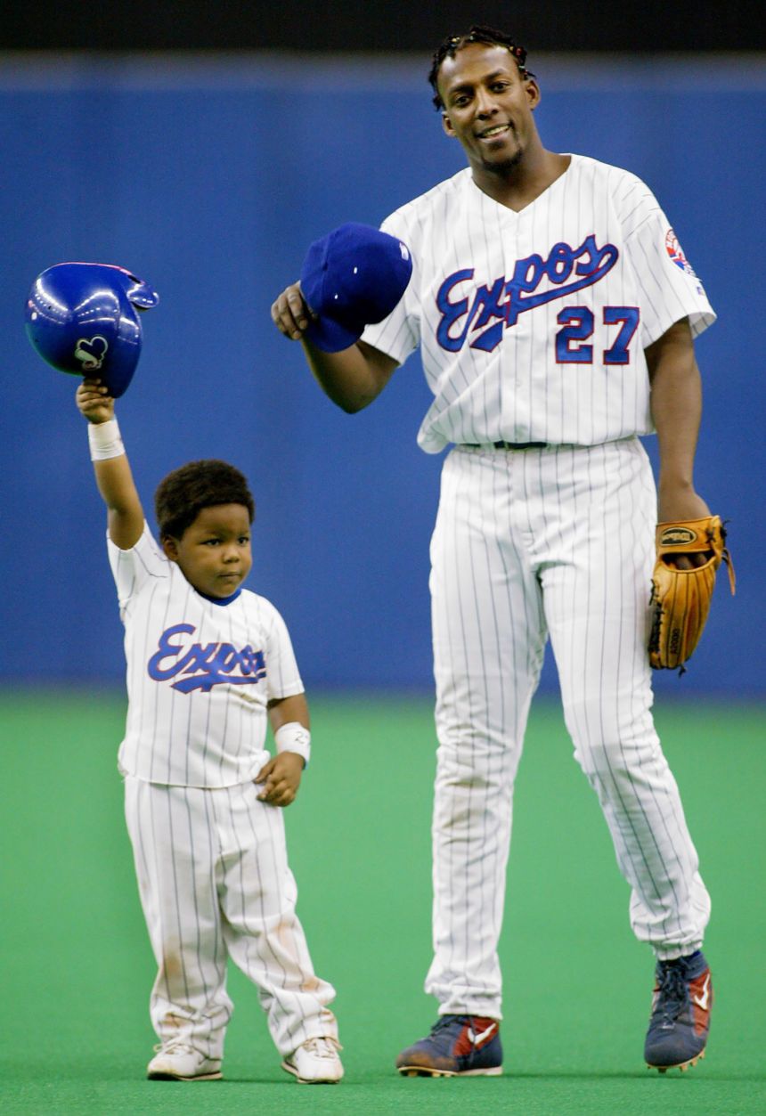 Vladimir Guerrero Sr. when he was playing for the Montreal Expos and his son Vladimir Jr. tip their caps to the crowd on September 29, 2002 in Montreal.