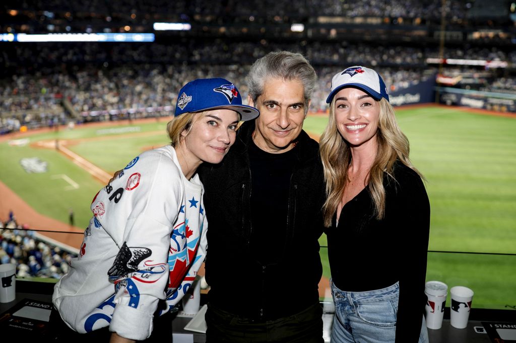 Annie Murphy, Michael Imperioli and Brianne Howey pose for a photo in the suite during Game Two of the 2025 World Series presented by Capital One between the Los Angeles Dodgers and the Toronto Blue Jays at Rogers Centre on Saturday, October 25, 2025 i