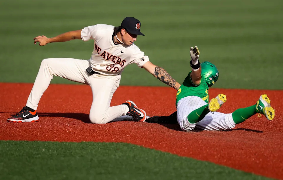 Oregon State infielder Aiva Arquette, left, tags out Oregon catcher Anson Aroz during an April 29 game at Goss Stadium in Corvallis. Arquette is expected to go early in Sunday's first round of the MLB draft.