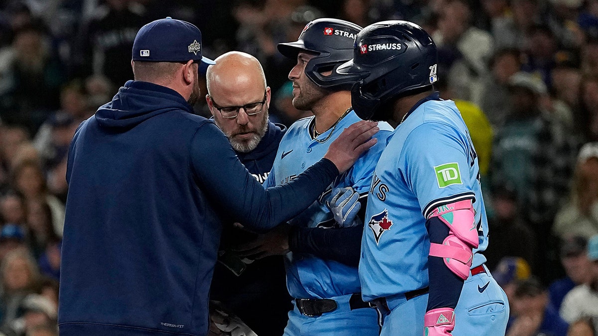 George Springer is helped by manager John Schneider