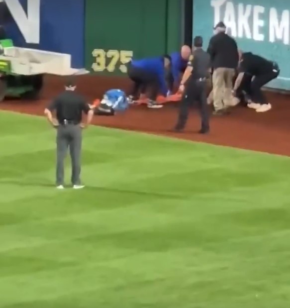 Emergency personnel attending to Kavan Markwood after a fall at an MLB game.