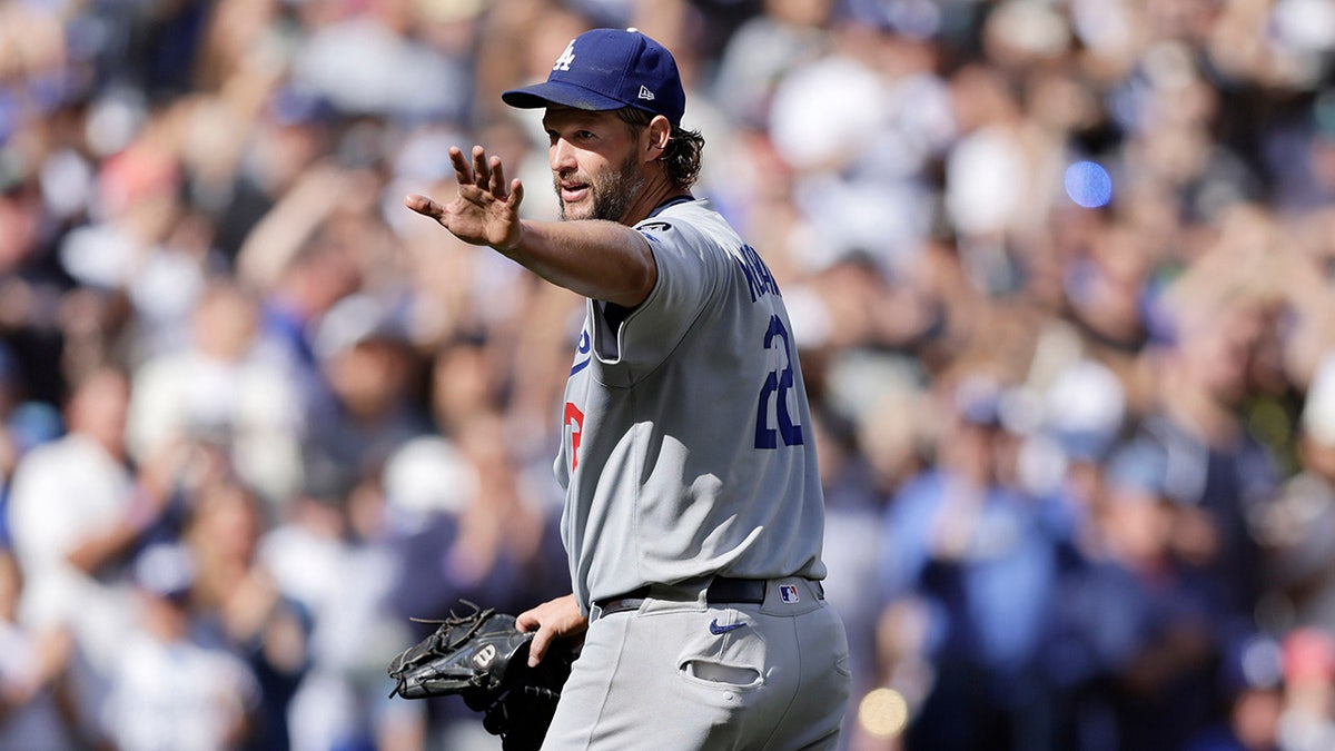 Clayton Kershaw waves to dugout