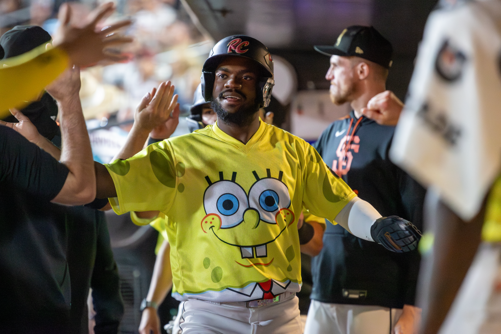 River Cats shortstop Oslevis Basabe, wearing a special SpongeBob-themed jersey for Nickelodeon Night, receives congratulations from his teammates after scoring during a Sept. 20 game at Sutter Health Park.