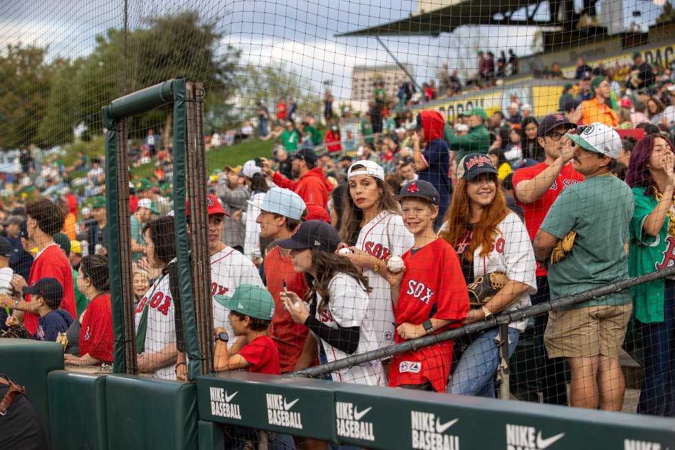 Boston Red Sox fans line up near the Sox’s dugout at Sutter Health Park on Sept. 9.