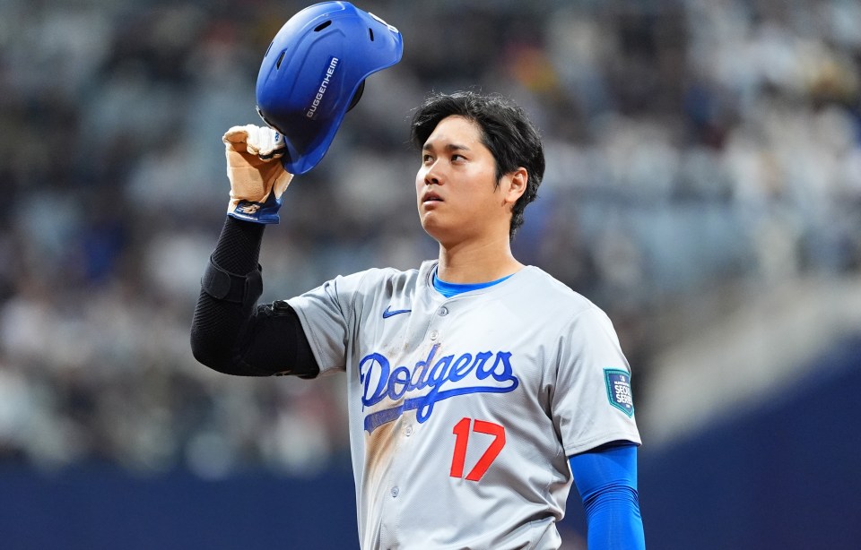 Shohei Ohtani of the LA Dodgers tips his helmet as he celebrates a hit