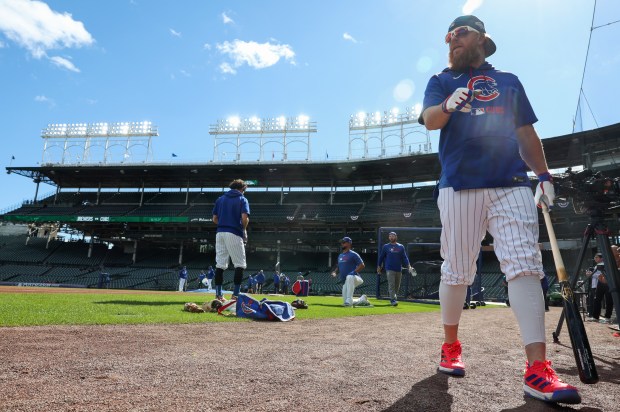 Cubs first baseman Justin Turner heads to the clubhouse before...