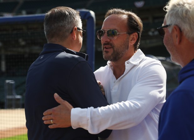 Cubs Chairman Tom Ricketts, left, greets his brother, co-owner Todd Ricketts, before the NLDS Game 3 against the Brewers at Wrigley Field on Oct. 8, 2025, in Chicago. (John J. Kim/Chicago Tribune)