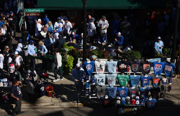 Fans mingle outside a pub on North Sheffield Avenue before the NLDS Game 3 between the Cubs and Brewers at Wrigley Field on Oct. 8, 2025, in Chicago. (John J. Kim/Chicago Tribune)