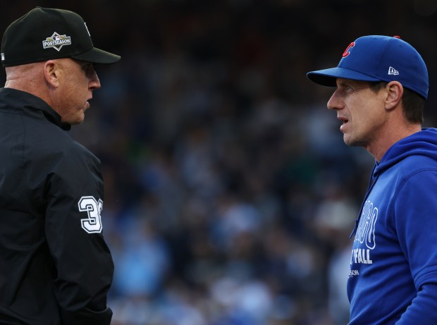 Cubs manager Craig Counsell argues a play call with the...