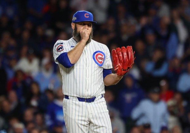 Cubs pitcher Andrew Kittredge warms up his hand while throwing...