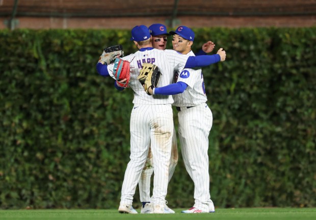 Cubs left fielder Ian Happ, from left, center fielder Pete...