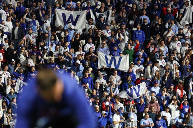 Fans celebrate after a 4-3 Cubs win over the Brewers...