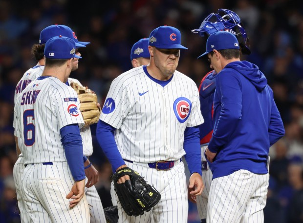 Cubs pitcher Caleb Thielbar, center, is taken out in the...