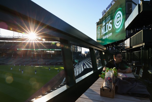A concessions worker takes a break before Game 4 of the NLCS between the Cubs and Brewers at Wrigley Field on Oct. 9, 2025, in Chicago. (John J. Kim/Chicago Tribune)