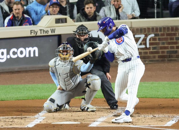 Cubs second baseman Nico Hoerner swings for a single against the Brewers in the first inning of Game 4 of the NLCS at Wrigley Field on Oct. 9, 2025, in Chicago. (John J. Kim/Chicago Tribune)
