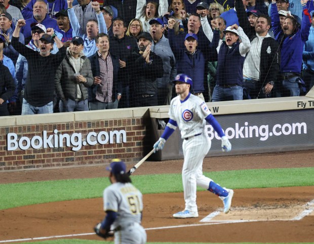 Fans cheer as Cubs left fielder Ian Happ watches his three-run home run in the first inning of Game 4 of the NLCS against the Brewers at Wrigley Field on Oct. 9, 2025, in Chicago. (John J. Kim/Chicago Tribune)