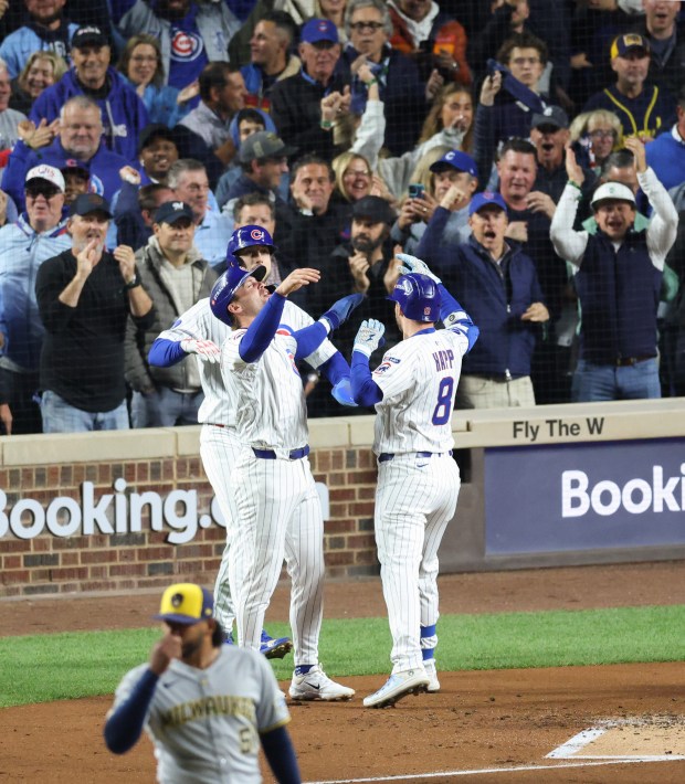 Cubs left fielder Ian Happ celebrates with teammates after hitting a three-run home run in the first inning of Game 4 of the NLCS against the Brewers at Wrigley Field on Oct. 9, 2025, in Chicago. (John J. Kim/Chicago Tribune)