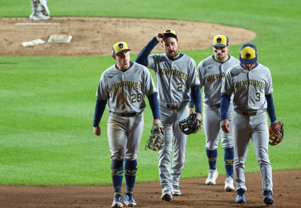 Brewers infielders walk away from the mound during a pitching...