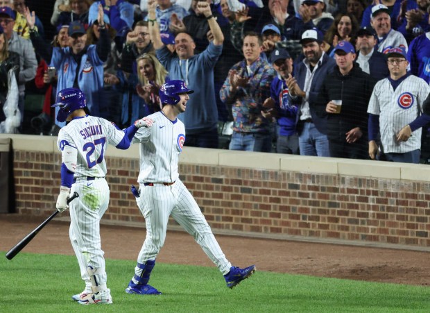 Cubs designated hitter Kyle Tucker, right, celebrates after hitting a home run in the seventh inning of Game 4 of the NLCS against the Brewers at Wrigley Field on Oct. 9, 2025, in Chicago. (John J. Kim/Chicago Tribune)