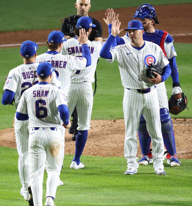 Cubs pitcher Caleb Thielbar, second from right, and catcher Carson...