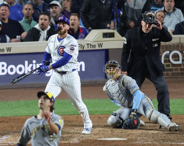 Cubs first baseman Michael Busch watches his solo home run off Brewers pitcher Robert Gasser in the eighth inning of Game 4 of the NLCS at Wrigley Field on Oct. 9, 2025, in Chicago. (John J. Kim/Chicago Tribune)