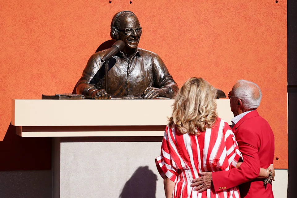 Amanda and Marty Brennaman observe the bronze statue of Marty at Crosley Terrace