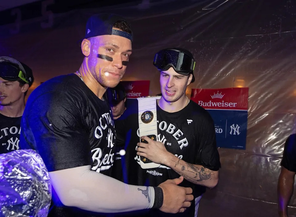Cam Schlittler #31 of the New York Yankees and Aaron Judge #99 of the New York Yankees celebrate in the clubhouse after the New York Yankees defeat the Boston Red Sox. Charles Wenzelberg / New York Post